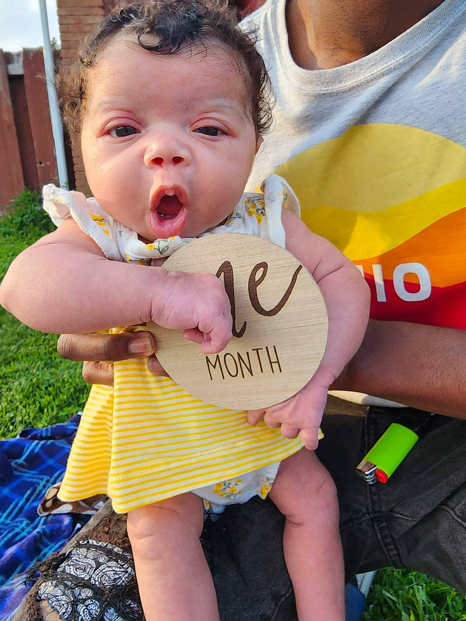 Mylah is registered to the contest to win money with this photo: baby, baby_toddler_clothing, child, event, fashion_accessory, finger, fun, gesture, grass, hand, happy, leisure, person, pink, plant, recreation, skin, t_shirt, thigh, toddler