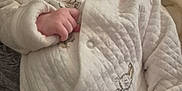 Lottie is registered to the contest to win money with this photo: baby, infant, face, person, clothing, quilted_fabric, peter_rabbit, blanket, soft_texture, cute, indoors, portrait, serious_expression, young_child, lying_down, hand, cozy, warm, child, comfortable