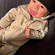 Jahzier joined the competition — help win amazing prizes! baby, smile, beanie, adidas, tracksuit, clothing, infant, happy, face, hand, lying_down, blanket, cozy, apparel, child, cute, expression, warm, portrait, indoor
