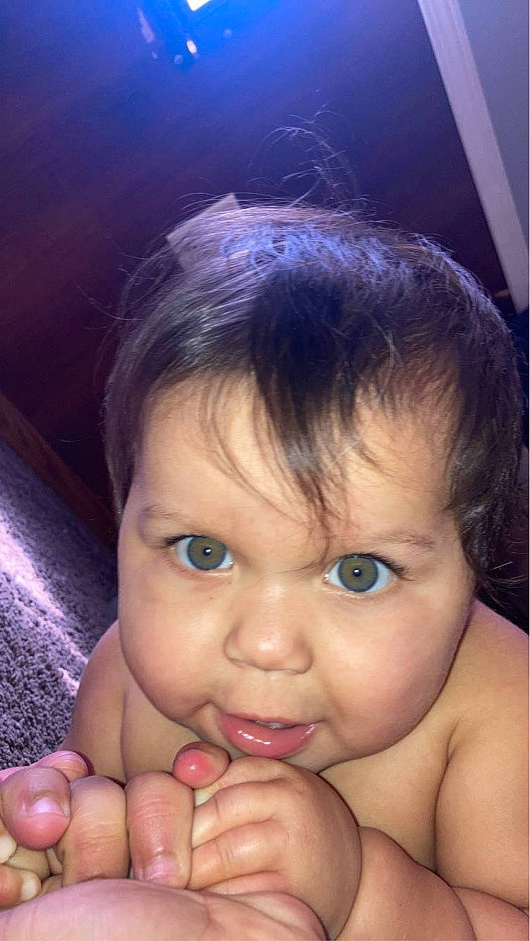 Nevaeh is registered to the contest to win money with this photo: baby, cheek, chin, ear, eyebrow, eyelash, face, finger, forehead, gesture, hair, hand, happy, iris, lip, mouth, nose, organ, person, skin