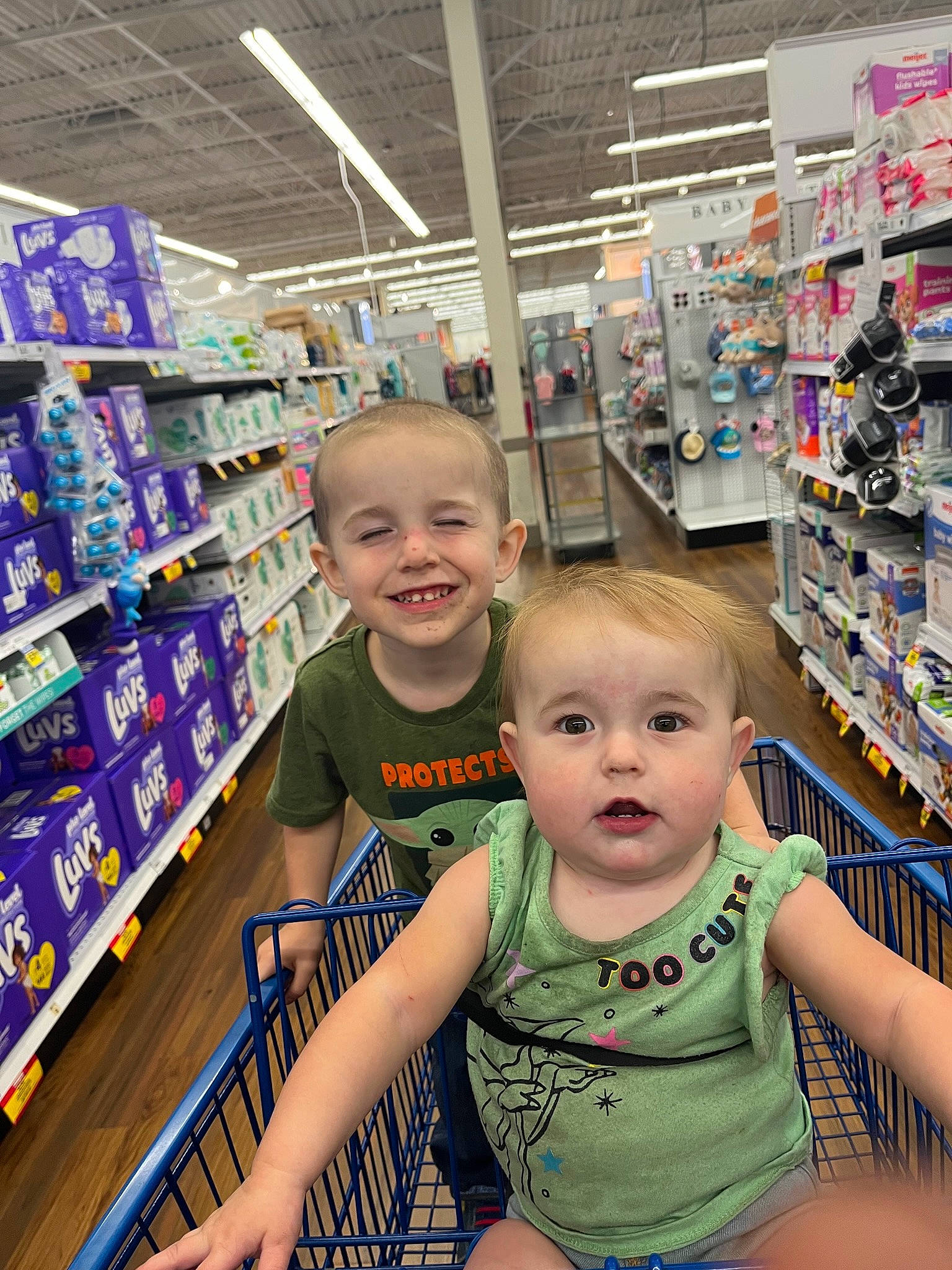 Lilith is registered to the contest to win money with this photo: baby, baby_toddler_clothing, child, convenience_store, customer, fun, happy, joy, person, product, publication, retail, service, shelf, shelving, shopping, skin, smile, standing, t_shirt
