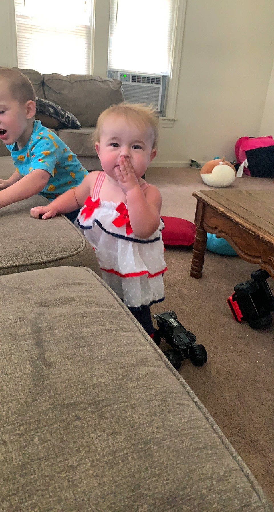 Lilith is registered to the contest to win money with this photo: asphalt, baby, baby_toddler_clothing, bag, child, curtain, dress, floor, flooring, fun, luggage_and_bags, office_supplies, person, play, room, sitting, t_shirt, toddler, wheel, window
