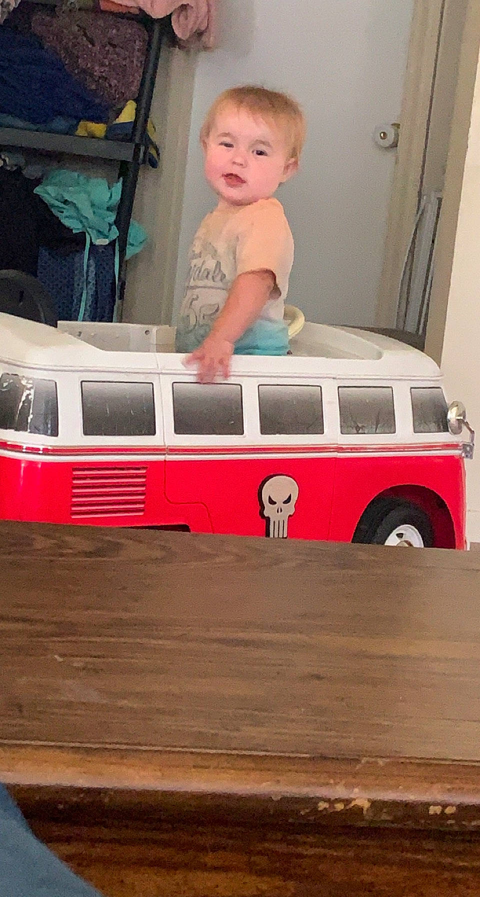 Lilith is registered to the contest to win money with this photo: automotive_design, automotive_exterior, baby_toys, child, doll, electric_blue, flooring, mode_of_transport, model_car, motor_vehicle, person, public_transport, tire, toddler, toy, toy_vehicle, train, vehicle, vehicle_door, wheel