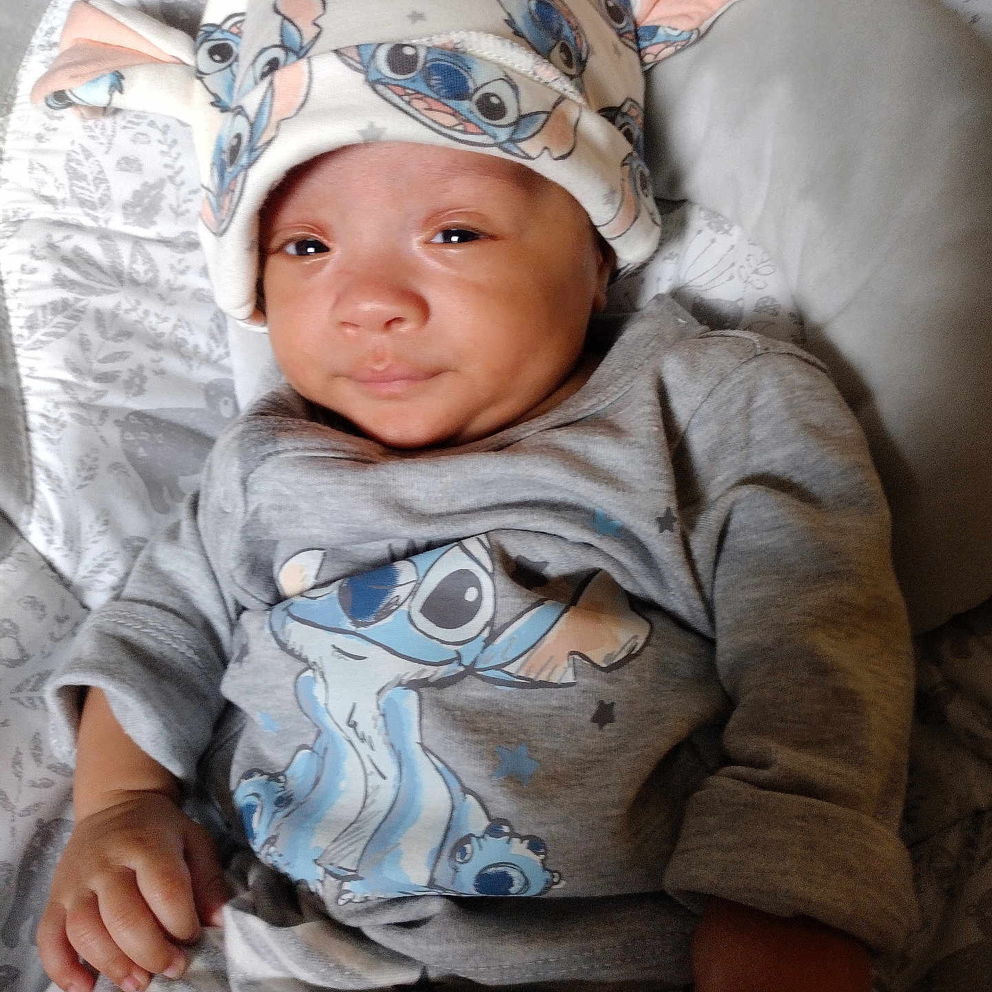 William joined the competition — help win amazing prizes! baby, cartoon_character, child, clothing, comfort, cozy, cute, face, gray_clothes, hand, hat, indoors, infant, lying_down, newborn, patterned_blanket, portrait, sleepy, smile, soft_toys