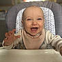 baby, high_chair, smiling, bib, infant, clothing, happy, reaching, face, person, indoor, kitchen, cute, child, toddler, feeding_time, expression, seat, young, portrait