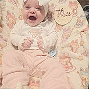 Sarina joined the competition — help win amazing prizes! baby, infant, smiling, headband, bow, blanket, plush_toy, onesie, pacifier, milestone_card, three_months, pink_clothing, adorable, happy, portrait, closeup, sitting, nursery, pattern, hand