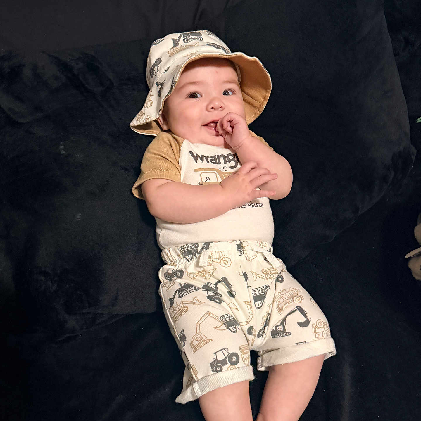 Wilder joined the competition — help win amazing prizes! baby, infant, hat, bucket_hat, shorts, shirt, couch, furniture, smile, happy, child, person, indoors, clothing, cute, face, hand, leg, foot, playful