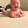 Wilder joined the competition — help win amazing prizes! baby, tummy, smile, happy, infant, bed, blanket, indoors, skin, hair, face, child, cute, newborn, expression, person, portrait, young, lying_down, cheerful