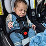 baby, sleeping, car_seat, pacifier, blue_outfit, sock, blanket, child, infant, safety_harness, warning_label, close_up, peaceful, indoor, person, seat, head, hand, comfort, rest