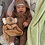 Kyaire is registered to the contest to win money with this photo: baby, infant, onesie, brown_clothing, plush_toy, koala, baby_seat, blanket, white_socks, cute, expression, face, indoor, carpet, soft_toy, hood, child, cozy, sleepwear, fist