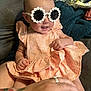 Alaina is registered to the contest to win money with this photo: accessories, baby, blanket, child, couch, cozy, cute, dress, fashion, hand, happy, home, indoor, infant, person, portrait, seated, smile, sunglasses, tattoo