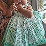 Alaina is registered to the contest to win money with this photo: baby, child, cute, door, dress, fingers, flower, green, hand, headband, holding, indoor, lace, person, screen, shoes, smiling, sunlight, white, window
