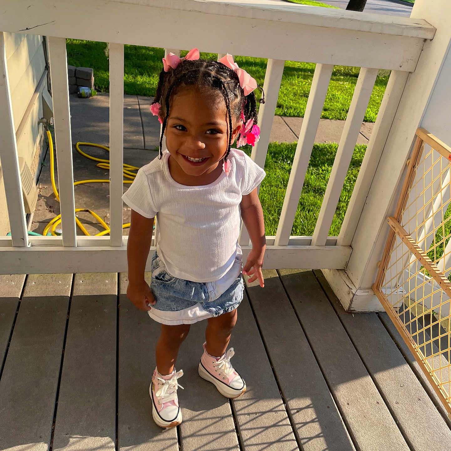 Nubian is registered to the contest to win money with this photo: architecture, building, child, clothing, deck, face, female, footwear, girl, head, house, housing, pants, person, photography, porch, portrait, shoe, shorts, t_shirt