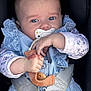 baby, infant, car_seat, pacifier, blue_eyes, hand, clothing, lace, floral_pattern, safety_belt, close_up, child, cute, person, young_child, portrait, indoor, secure, seat_belt, holding