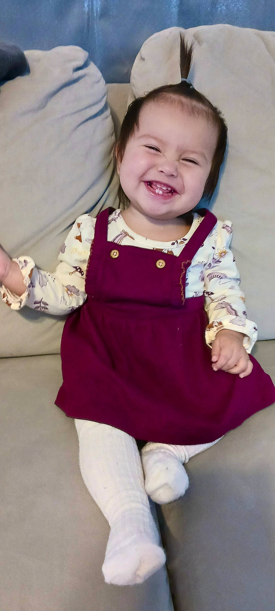 Milliana is registered to the contest to win money with this photo: baby, baby_toddler_clothing, cheek, child, collar, dress, electric_blue, face, fashion_accessory, gesture, hand, happy, joy, magenta, pattern, person, pink, purple, sleeve, smile