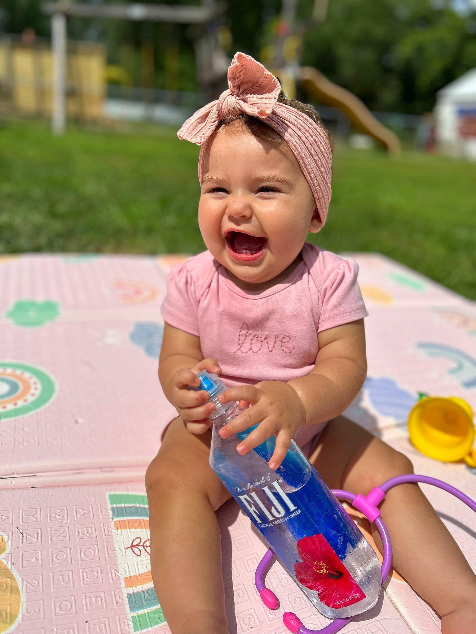 Amaya is registered to the contest to win money with this photo: baby, baby_toddler_clothing, cap, child, facial_expression, fun, grass, happy, hat, leisure, person, pink, plant, purple, recreation, skin, smile, summer, sun_hat, toddler