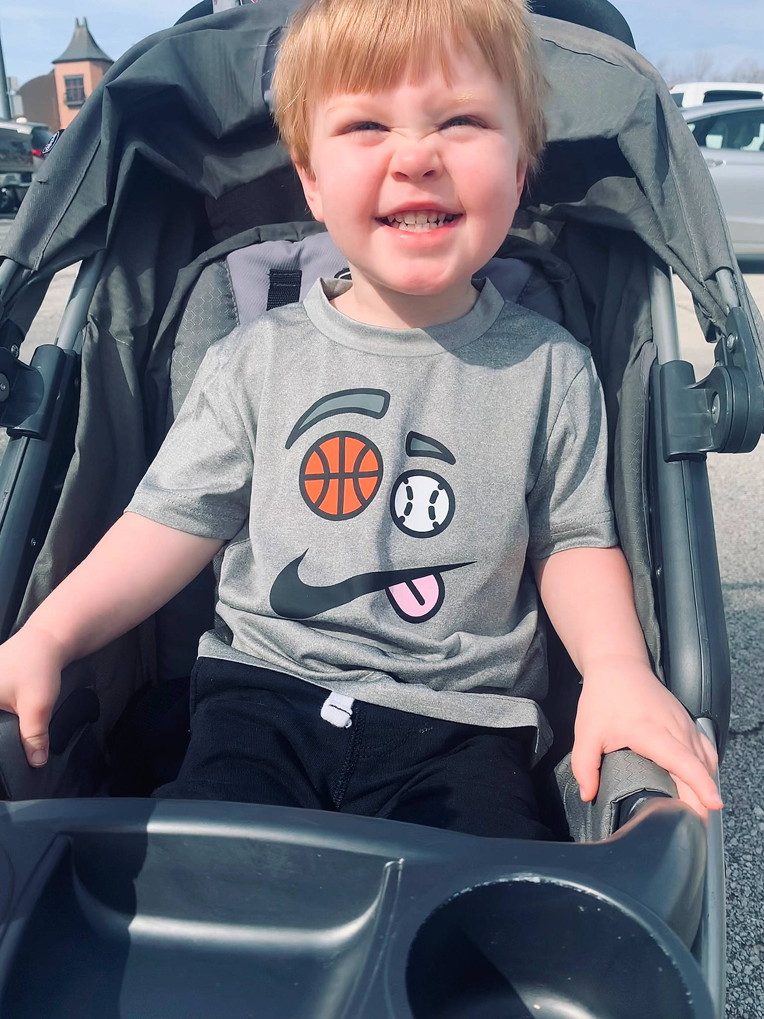 Rayden is registered to the contest to win money with this photo: automotive_design, automotive_exterior, automotive_tire, baby_carriage, blue, bumper, car_seat, cool, facial_expression, hairstyle, hood, joy, motor_vehicle, people, person, product, sky, smile, t_shirt, toddler