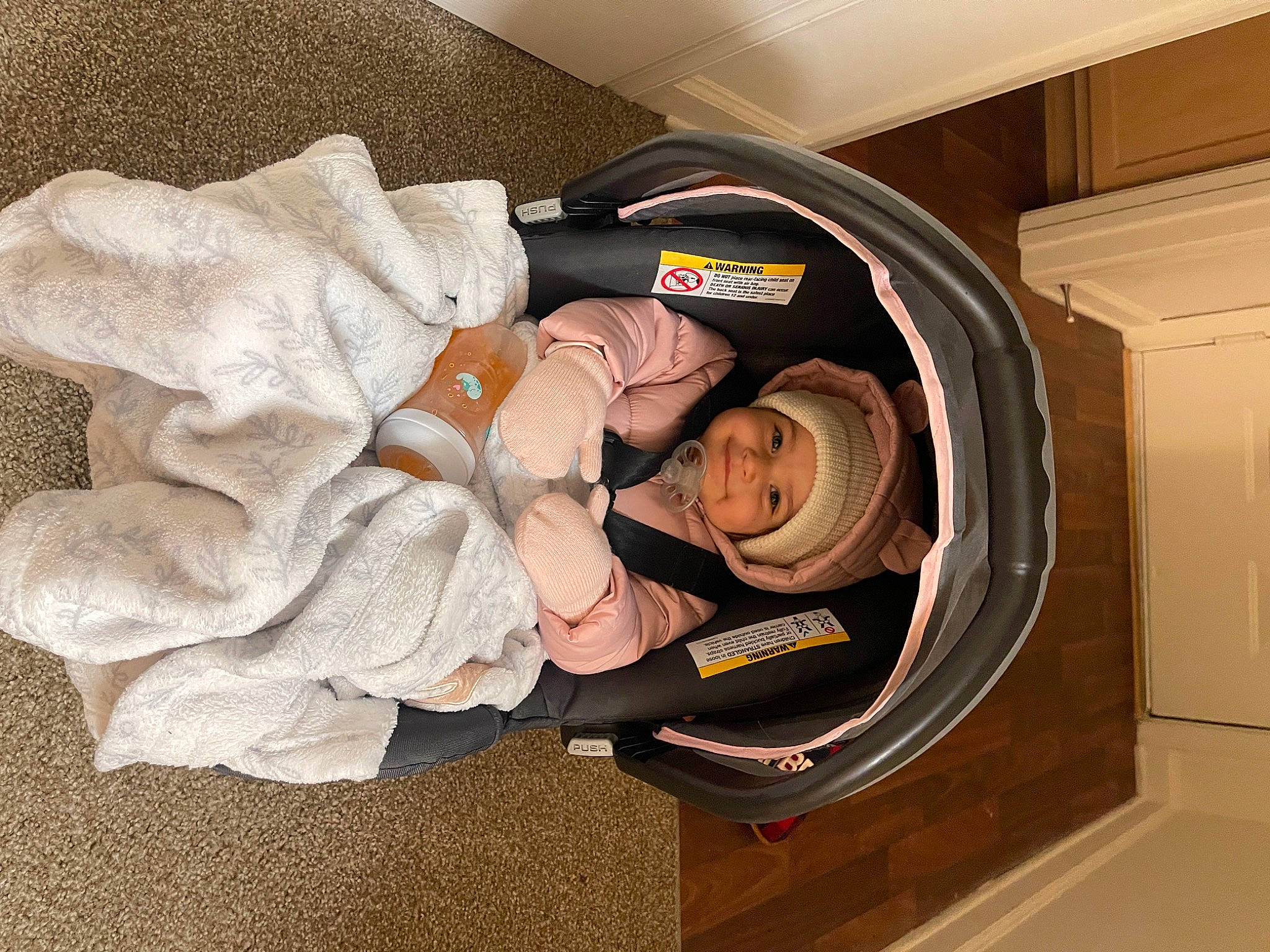 Iyla is registered to the contest to win money with this photo: auto_part, automotive_tire, automotive_wheel_system, baby_products, baby_toddler_clothing, circle, comfort, headwear, machine, person, room, smile, tire, wheel, wood, wrist