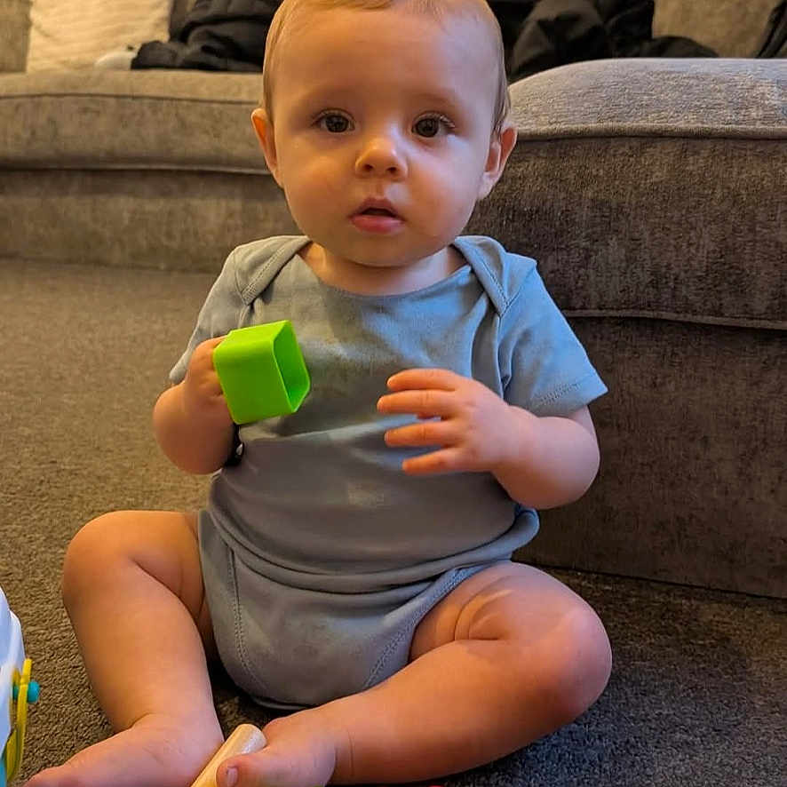 Grayson joined the competition — help win amazing prizes! architecture, baby, bodypart, building, couch, face, finger, furniture, hand, head, indoors, interiordesign, livingroom, person, photography, portrait, room, sitting, tape, toy