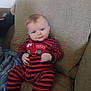 Theo joined the competition — help win amazing prizes! baby, infant, couch, striped_clothing, red, navy, onesie, fire_truck, hand, face, smile, seated, furniture, indoors, textile, blanket, comfort, cute, child, portrait