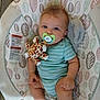 Theo is registered to the contest to win money with this photo: baby, pacifier, plush_toy, giraffe, onesie, infant, child, seat, pattern, striped_clothing, cute, comfort, toy, indoor, soft_toy, baby_seat, relaxed, small_child, blue, green
