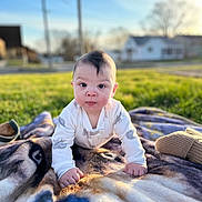 Jace is registered to the contest to win money with this photo: baby, infant, crawling, blanket, outdoor, grass, sunlight, face, head, expression, clothing, child, nature, yard, house, moawk, portrait, cute, young, daylight
