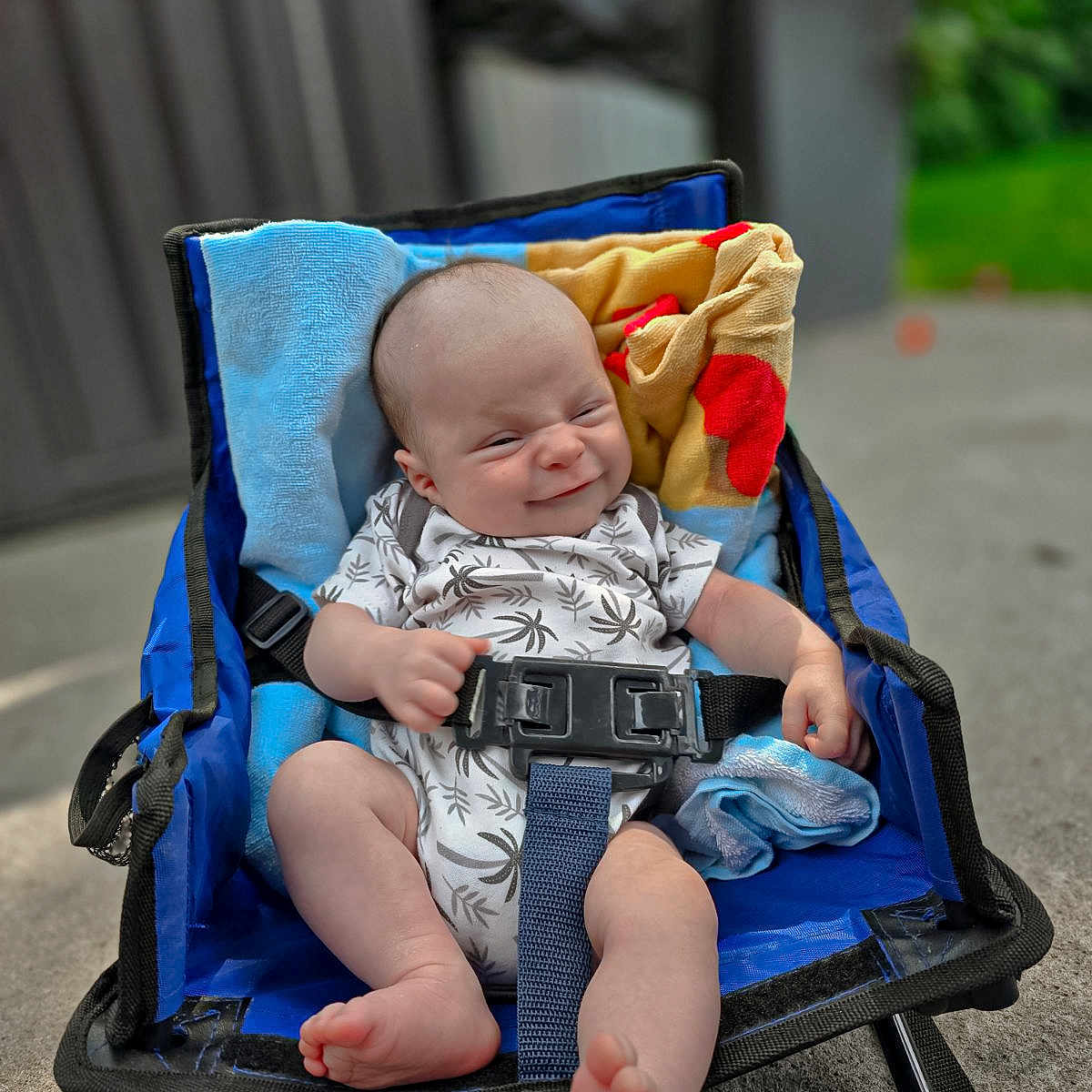 Luca is registered to the contest to win money with this photo: accessories, baby, bodypart, chair, clothing, electronics, face, finger, furniture, hand, head, newborn, pants, person, photography, portrait, sitting, sleeping, strap, stroller