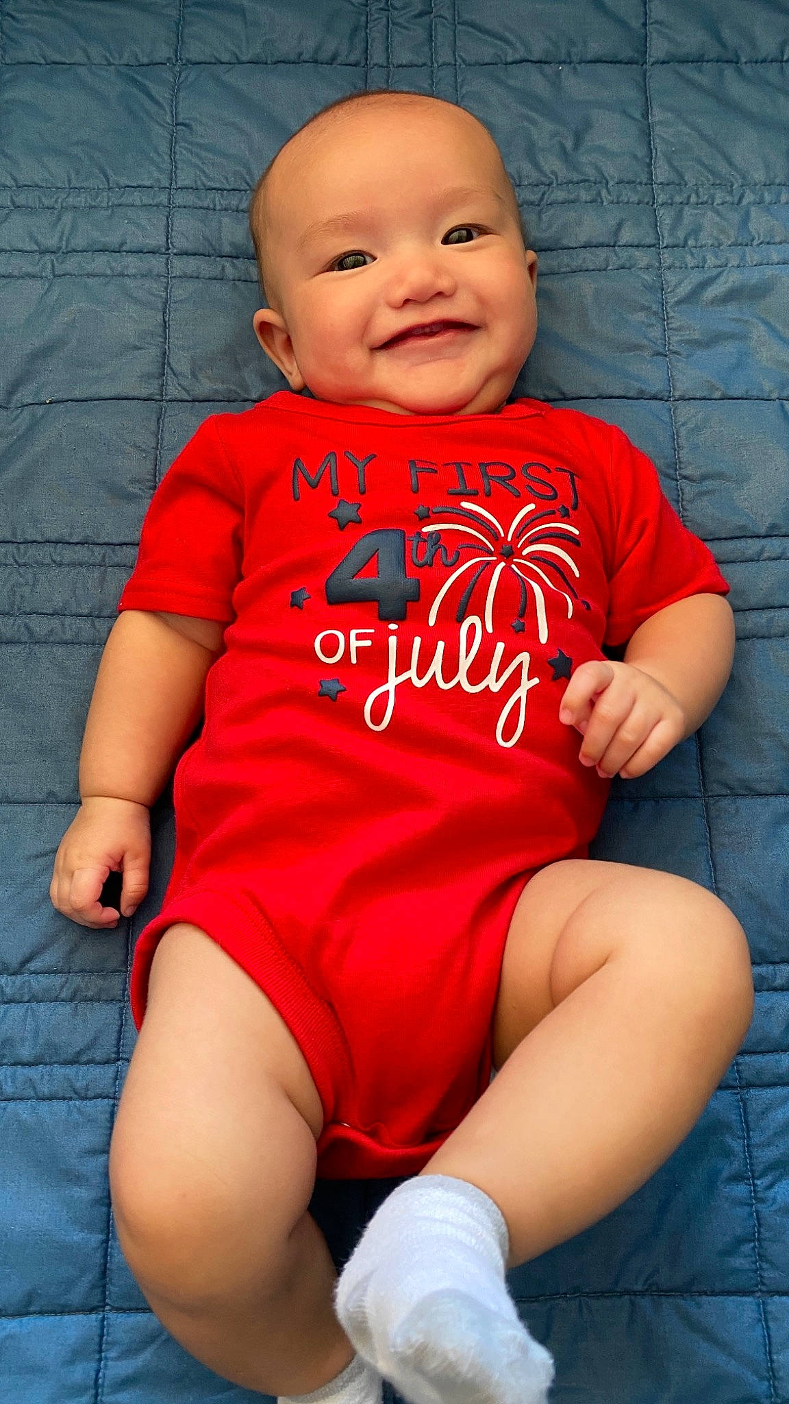 Gabriel is registered to the contest to win money with this photo: arm, baby_toddler_clothing, chin, comfort, dress, eye, finger, happy, head, human_body, joy, lip, muscle, orange, person, pink, red, shoulder, skin, sleeve