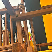 Landon joined the competition — help win amazing prizes! child, playground, wooden_structure, railing, yellow, black, outdoor, daylight, person, clothing, jeans, hand, face, smile, tree, sky, play, fun, kids, adventure