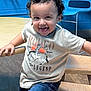 Joseph Jacob Jr joined the competition — help win amazing prizes! toddler, child, curly_hair, smiling, tongue_out, jeans, tshirt, sneakers, wooden_bench, playroom, blue_wall, blue_chair, floor, indoor, happy, cute, person, casual_clothing, playful, young_child
