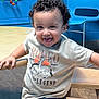 Joseph Jacob Jr joined the competition — help win amazing prizes! toddler, child, curly_hair, smiling, tongue_out, tshirt, jeans, wooden_chair, playroom, blue_wall, bead_maze, table, indoor, happy, person, casual_clothing, furniture, young_child, playful, seated