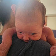 Leon is registered to the contest to win money with this photo: baby, infant, person, skin, face, head, arm, shoulder, closeup, expression, newborn, human, indoor, young_child, holding, cute, portrait, tender, soft_light, intimate
