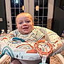 baby, infant, smiling, high_chair, bouncer, toy_ring, striped_shirt, indoor, kitchen, countertop, water_bottle, door, window, pendant_light, portrait, cute, happy, face, teething, home