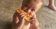 Bowen is registered to the contest to win money with this photo: baby, barefoot, blond_hair, blue_eyes, bread, candid, chairs, child, concrete_floor, diaper, eating, face, food, hands, happy, home, indoor, infant, portrait, sitting