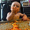 Bowen joined the competition — help win amazing prizes! baby, child, high_chair, eating, messy, food, sauce, pasta, ravioli, orange_sauce, smiling, face, hands, indoor, kitchen, portrait, sitting, tray, self_feeding, funny