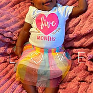 Victoria is registered to the contest to win money with this photo: baby, infant, child, portrait, smiling, happy, lying_down, pink_blanket, bow, headband, tutu, skirt, rainbow, white_shirt, five_months, indoor, bed, text_overlay, cute, photography