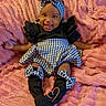Victoria joined the competition — help win amazing prizes! baby, child, infant, smiling, sitting, portrait, indoor, blanket, pink_blanket, dress, houndstooth, headband, bow, ruffles, black_clothing, shoes, heart_pose, happy, furniture, photography