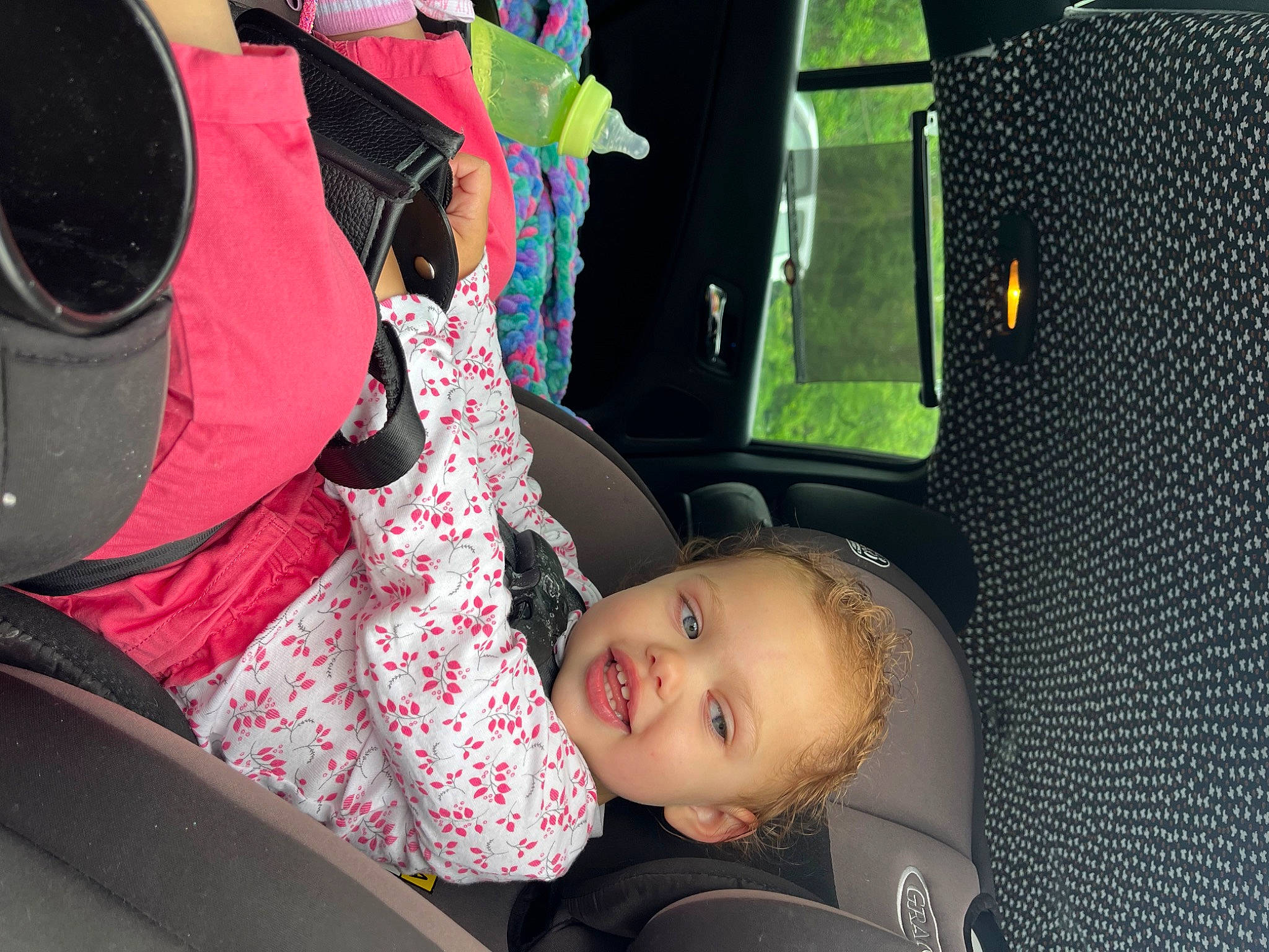 Octavia is registered to the contest to win money with this photo: auto_part, automotive_design, automotive_exterior, automotive_lighting, automotive_tire, automotive_wheel_system, beauty, black_hair, car, car_seat, child, fun, goggles, joy, motor_vehicle, person, tints_and_shades, toddler, tree, vehicle