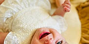 Héloïse a rejoint le concours — aidez-le/la à gagner de superbes lots ! baby, blanket, blue_eyes, child, close_up, cute, expression, face, hand, happy, head, indoors, infant, lying_down, portrait, skin, smile, soft_toys, white_dress, young_child