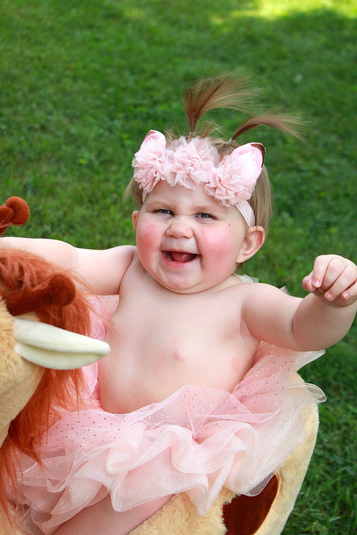Annalise is registered to the contest to win money with this photo: art, baby, baby_toddler_clothing, child, event, fashion_accessory, fun, gesture, grass, hair_accessory, happy, headband, headgear, headpiece, headwear, jewellery, joy, person, petal, pink