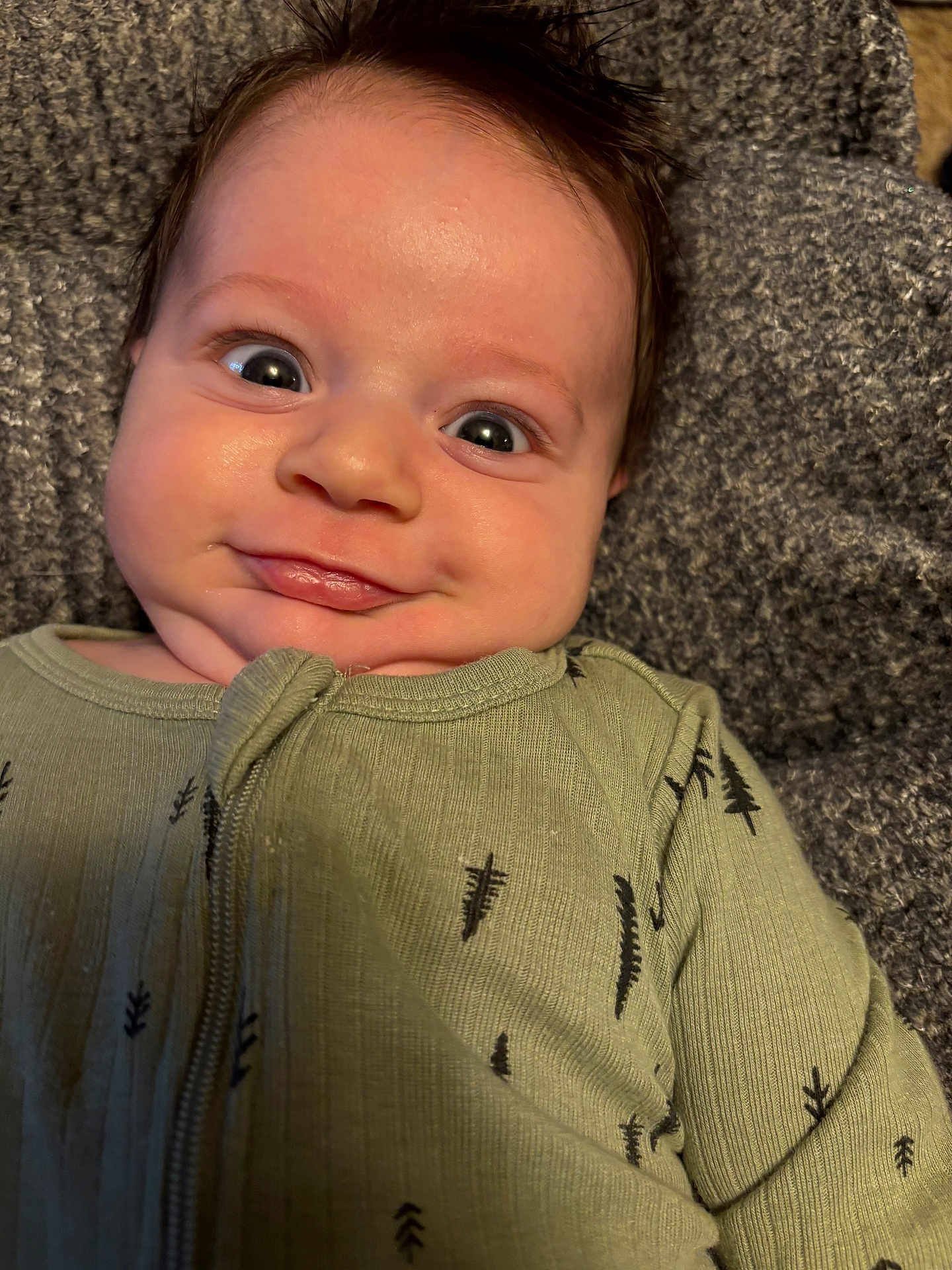 Heath is registered to the contest to win money with this photo: baby, bodypart, clothing, couch, face, finger, furniture, hand, happy, hat, head, hoodie, knitwear, newborn, person, photography, portrait, smile, sweater, sweatshirt