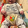applique, baby, bodypart, chair, clothing, couch, cushion, face, finger, furniture, hand, head, homedecor, pants, pattern, person, photography, portrait, sitting, t_shirt