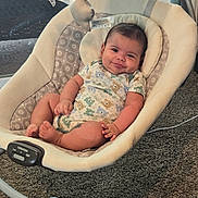 Sebastian is registered to the contest to win money with this photo: baby, infant, baby_swing, smile, baby_clothing, plush_toys, star_toys, carpet, indoor, child, person, cute, relaxing, seat, baby_boy, toy, soft, home, comfort, happy