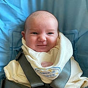 Gemma joined the competition — help win amazing prizes! baby, infant, child, smile, face, car_seat, harness, blue, white, clothing, bib, cute, portrait, indoors, sitting, happy, young, head, secure, rest