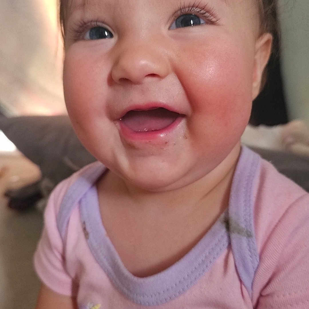 Melody is registered to the contest to win money with this photo: baby, child, smile, happy, onesie, unicorn, rainbow, indoor, portrait, cute, face, infant, eyelashes, pink_clothing, magic, closeup, soft_light, rosy_cheeks, person, young_child