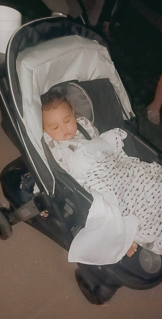 James is registered to the contest to win money with this photo: baby, baby_carriage, baby_products, baby_safety, baby_toddler_clothing, child, comfort, event, infant_bed, lap, monochrome, monochrome_photography, person, room, sitting, toddler