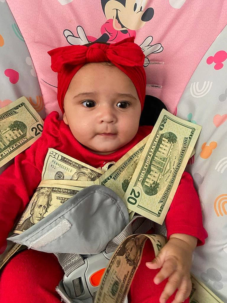 Nawaj joined the competition — help win amazing prizes! baby, baby_toddler_clothing, banknote, beauty, cash, child, costume_hat, currency, dollar, eyelash, facial_expression, fashion_accessory, happy, head, headwear, money, money_handling, person, pink, saving