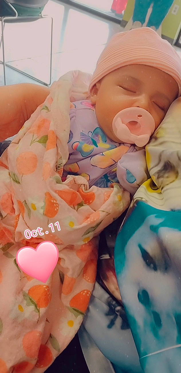 Nawaj is registered to the contest to win money with this photo: baby, baby_products, baby_sleeping, baby_toddler_clothing, cap, child, comfort, happy, hat, headwear, human_body, linens, orange, pattern, peach, person, pink, room, sweetness, textile