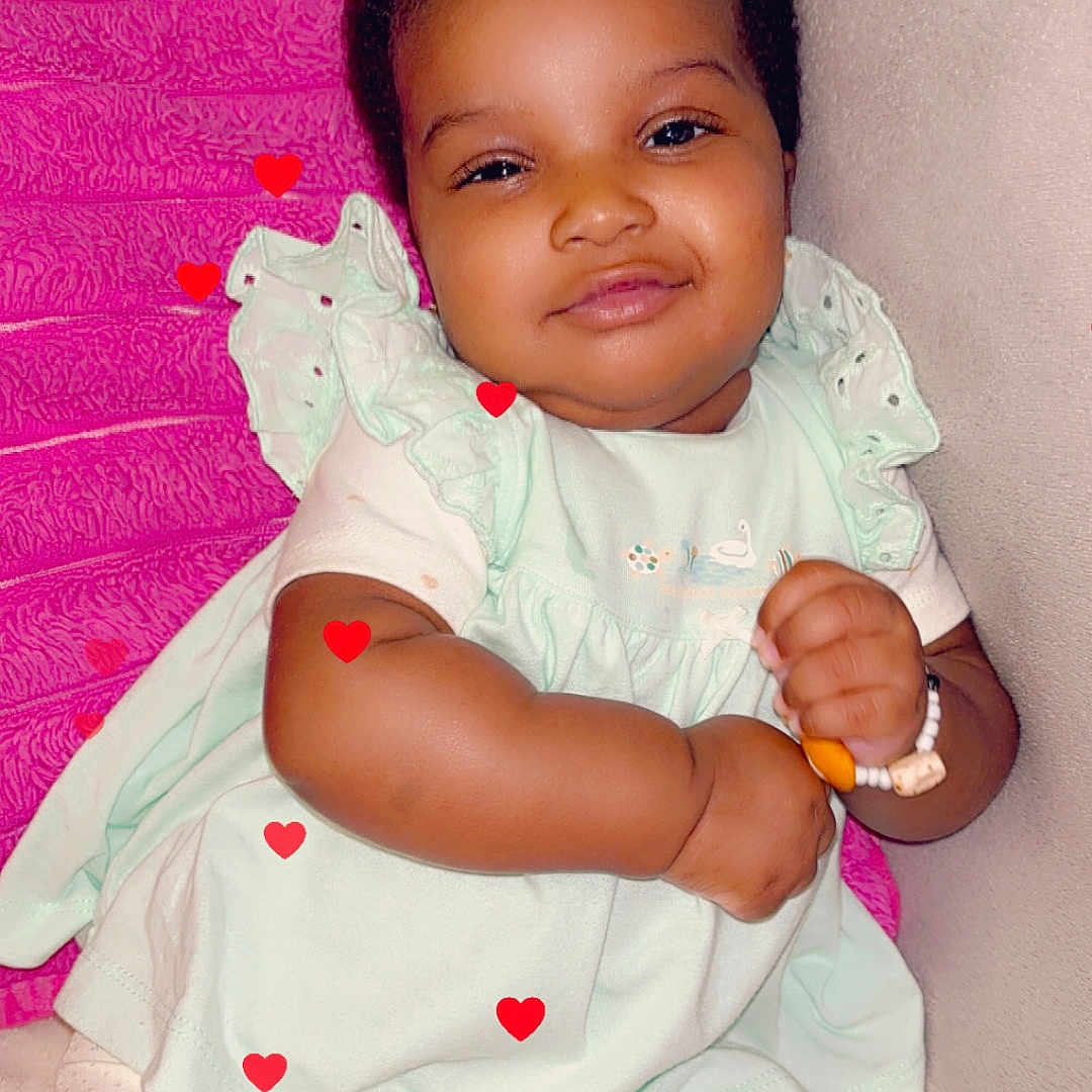 Kany a rejoint le concours — aidez-le/la à gagner de superbes lots ! baby, bracelet, child, clothing, comfort, couch, cute, face, happy, heart_graphics, indoors, infant, mint_green, pillow, pink, plush, relaxed, sitting, smiling, soft