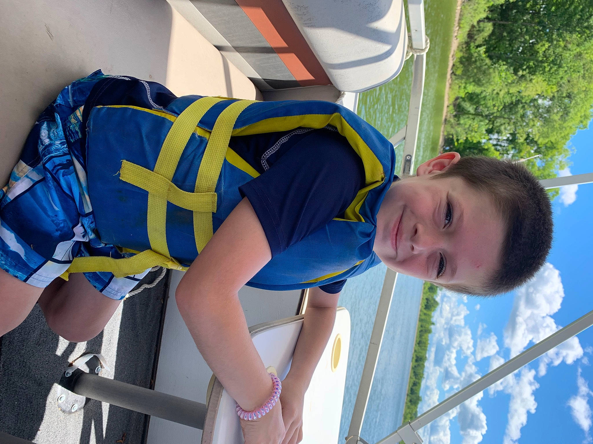 Gannon is registered to the contest to win money with this photo: azure, elbow, electric_blue, fun, happy, hat, human_leg, joint, joy, knee, leisure, person, shorts, sports_uniform, sportswear, t_shirt, thigh, toddler, tree, trunk